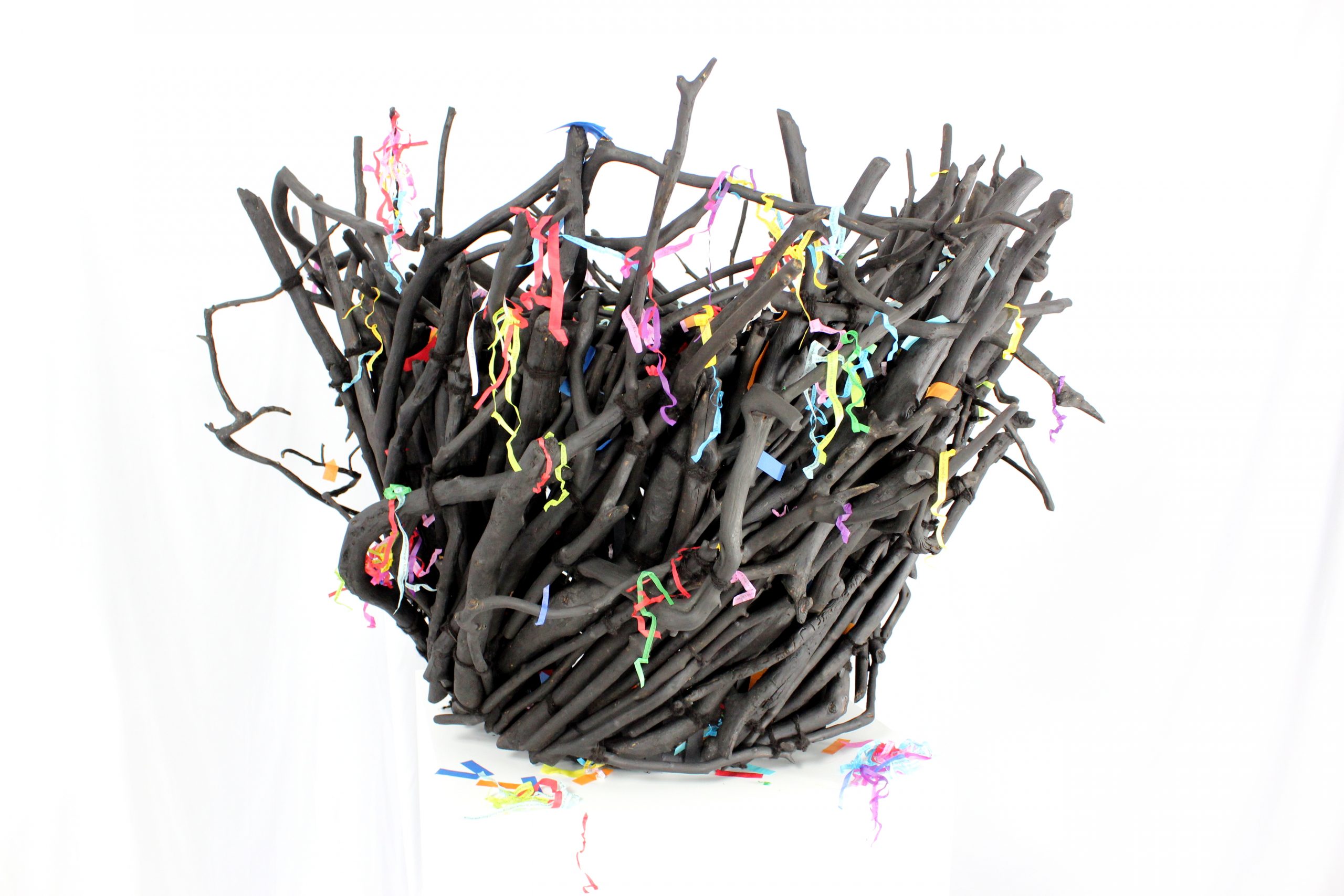 Basket woven with charred branches covered in confetti